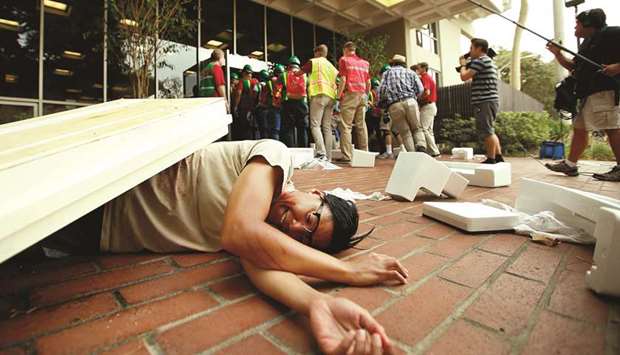 DRILL: A student lays on the ground simulating injuries sustained in an earthquake as media follow members of USCu2019s Campus Emergency Response Team during a drill in Los Angeles.