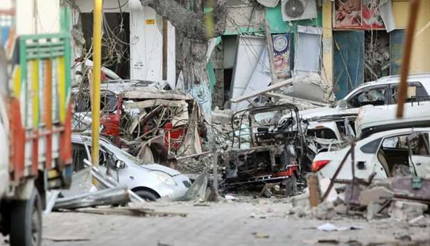Damaged cars are seen at the scene where a suicide car bomb exploded targeting a Mogadishu hotel in a business center in Maka Al Mukaram street in Mogadishu