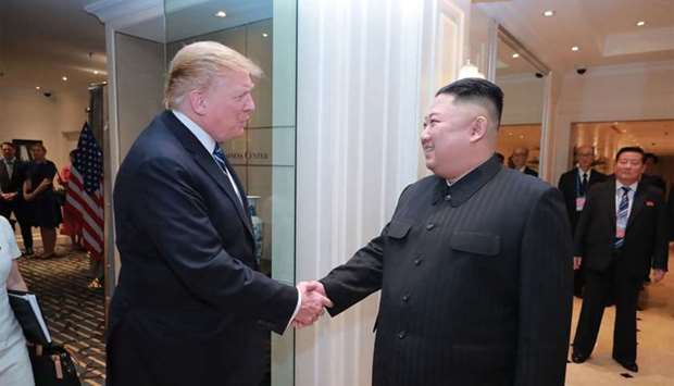 This picture from North Korea's official Korean Central News Agency (KCNA) taken on February 28, 2019 and released on March 1, 2019 shows North Korean leader Kim Jong Un (R) and US President Donald Trump shaking hands at the Sofitel Legend Metropole hotel in Hanoi.