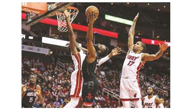 Houston Rocketsu2019 James Harden (right) shoots the ball as Miami Heatu2019s Bam Adebayo defends during the NBA match in Houston on Thursday. (USA TODAY Sports)