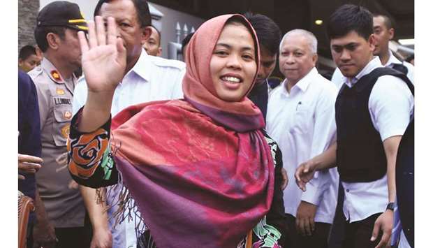 Indonesian Siti Aisyah waves after a press conference in Jakarta yesterday.