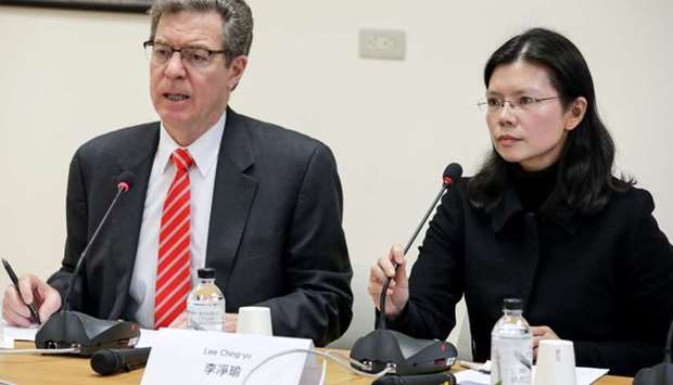 US Ambassador for Religious Freedom Sam Brownback and Lee Ching-yu, wife of Taiwan human rights advocate Lee Ming-che, also known as Li Ming-Che, attend an news conference in Taipei,