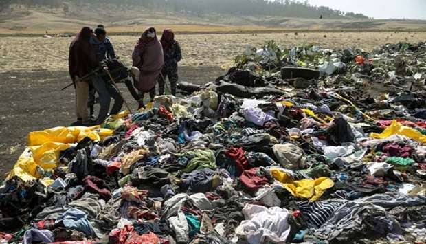 Ethiopian policemen search through the passengers belongings at the scene of the Ethiopian Airlines Flight ET 302 plane crash, near the town Bishoftu, near Addis Ababa. March 12, 2019 Reuters file picture