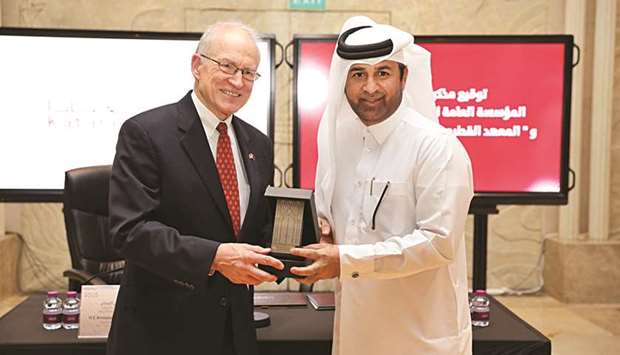Chase Untermeyer receives a memorial shield from Dr Khalid bin Ibrahim al-Sulaiti at the MoU signing yesterday.