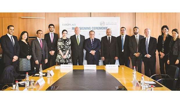 Al-Jaida and other QFC officials after signing the MoUs.