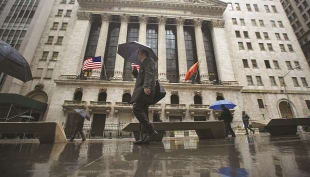 Pedestrians walking past the New York Stock Exchange (file). Forecasters see that the trend of lower bond yields as a worrying sign the US economy and corporate earnings arenu2019t strong enough to justify S&P 500 indexu2019s 17% rebound from its December low.