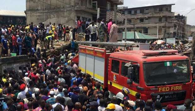 Rescue workers are seen at the site of a collapsed building containing a school in Nigeria's commercial capital of Lagos, Nigeria
