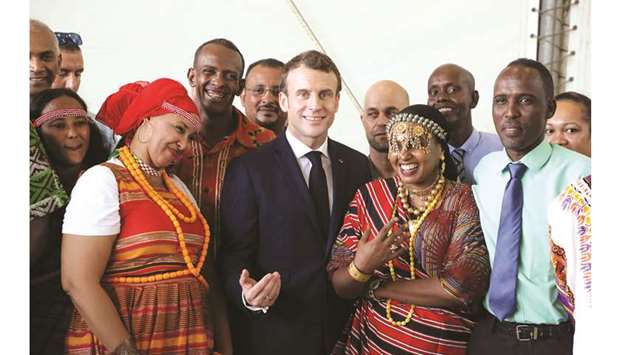 French President Emmanuel Macron meets with members of a traditional group on the French military base in Djibouti yesterday.