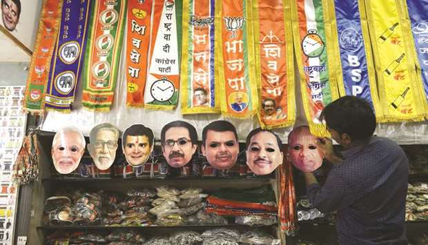 A trader puts up face masks of political leaders at a shop in Mumbai yesterday. India will hold a general election over nearly six weeks starting on April 11, when hundreds of millions of voters will cast ballots in the worldu2019s biggest democracy.