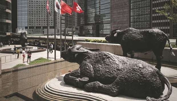 Bull statues displayed outside the stock exchange in Hong Kong. The Hang Seng Index is the least volatile relative to the Shanghai Composite since 2016, in terms of 30-day historical data.