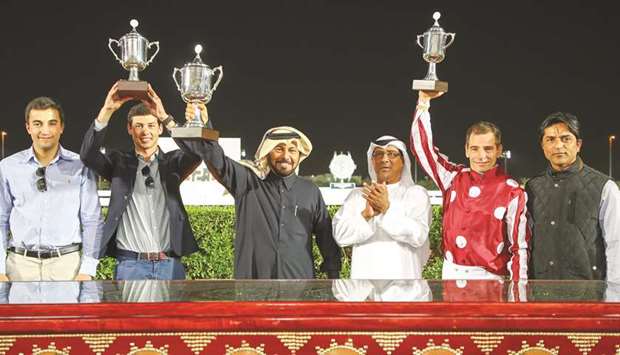 Qatar Racing and Equestrian Club (QREC) Racing manager Abdulla Rashid al-Kubaisi (third from right) with the winners of the Rodat Al Maida Cup after Umm Qarnu2019s Damas won the feature at the Al Rayyan Park yesterday. PICTURES: Juhaim