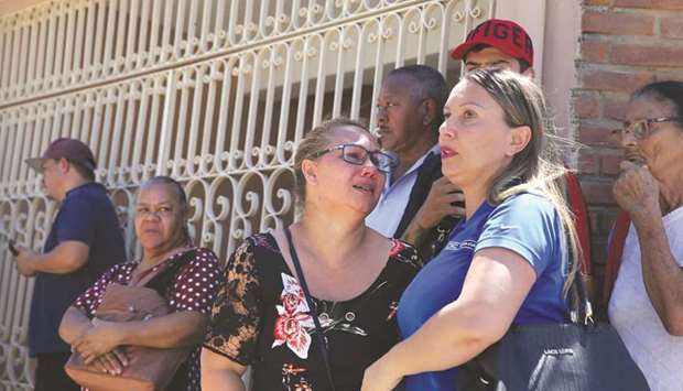 Relatives gather in front of the Raul Brasil school after a shooting in Suzano, Sao Paulo state, Brazil, yesterday.