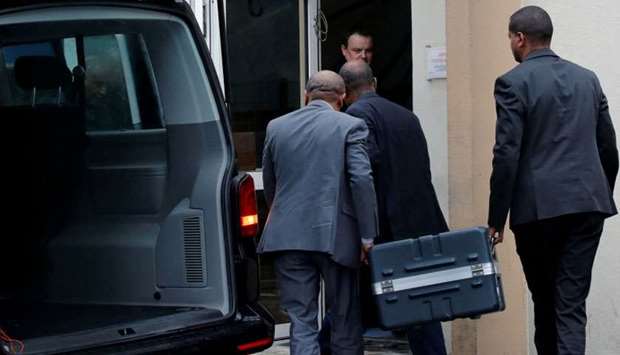 Men unload a case containing the black boxes from the crashed Ethiopian Airlines Boeing 737 MAX 8 outside the headquarters of France's BEA air accident investigation agency in Le Bourget
