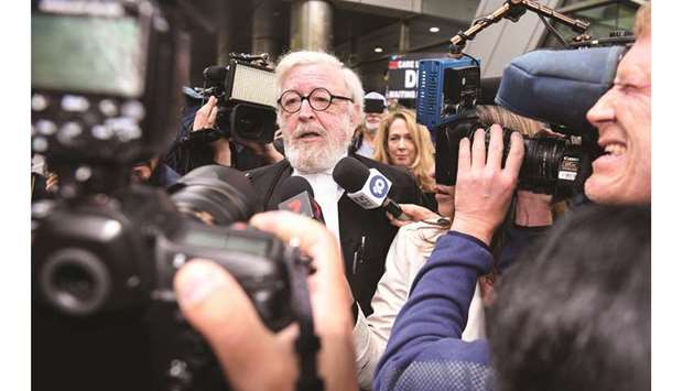 Robert Richter (centre), barrister for Cardinal George Pell, is surrounded by the media as he leaves the County Court after Pell was sentenced to six years in jail for child sex crimes, in Melbourne, yesterday.
