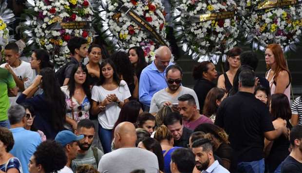Relatives and friends of five victims of the Raul Brasil public school shooting pay their respects during a collective wake in Suzano, Sao Paulo metropolitan region