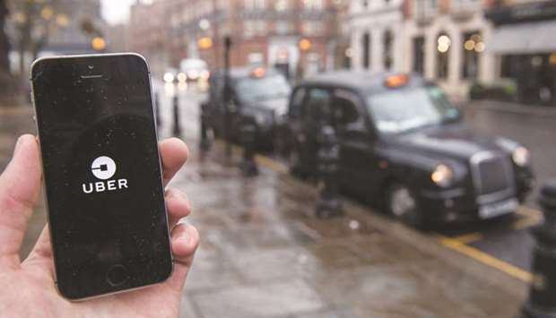 An Uber Technologies logo is seen on a smartphone display in in London. Selling a piece of the self-driving business would allow Uber to offload part of a very expensive endeavour, as it faces scrutiny from prospective investors in an initial public offering planned for the coming months.