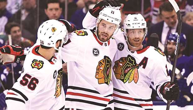 Chicago Blackhawks forward Brendan Perlini (centre) celebrates his goal with defenseman Duncan Keith (rightt) and Erik Gustafsson in the first period against Toronto Maple Leafs at Scotiabank Arena. PICTURE: USA TODAY Sports