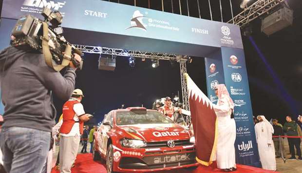 Qataru2019s Nasser Saleh al-Attiyah is flagged off from the podium for the Manateq Qatar International Rally at Souq Al Wakrah yesterday.