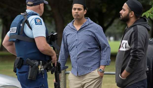 Witnesses and police at the south end of Deans Avenue after a shooting incident at the Al Noor mosque in Christchurch, New Zealand