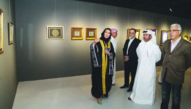 One of the artists briefing Dr al-Sulaiti and other dignitaries about the works on show.