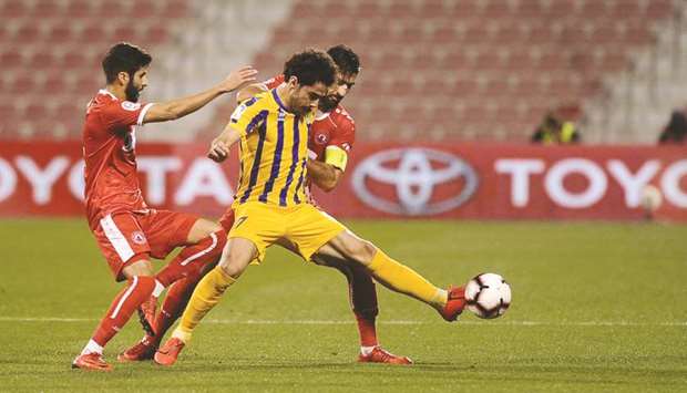 Al Gharafau2019s Ahmed Alaaeldin (centre) battles for the ball with Al Arabi defenders during the QNB Stars League match at the Al Arabi Stadium yesterday.