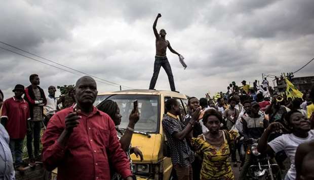 Supporters of Franck Diongo, the leader of the Lumumbist Progressive Movement (MLP) political party, sing and dance ahead of his release after two years in prison on March 16, 2019 in Kinshasa