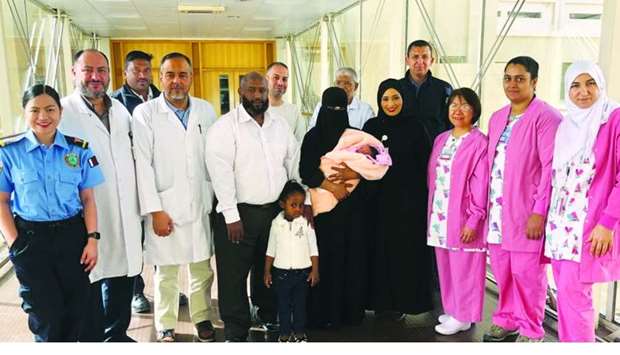 The Abdelawel family with Asmaa al-Atey and members of HMC care teams.