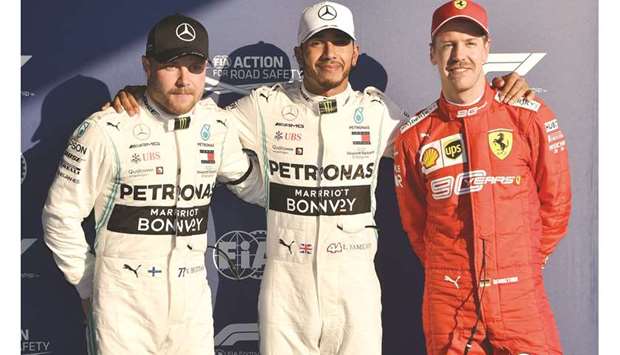 Mercedesu2019 Lewis Hamilton (centre) poses for a photo after taking pole position for the Australian Grand Prix with teammate Valtteri Bottas (left) in second and Ferrariu2019s Sebastian Vettel in third in Melbourne yesterday. (AFP)