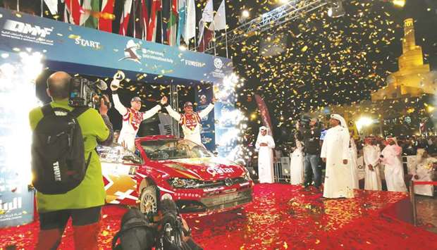 Qataru2019s Nasser Saleh al-Attiyah and his French co-driver Matthieu Baumel celebrate with their trophies on the podium after winning the Manateq Qatar International Rally yesterday.