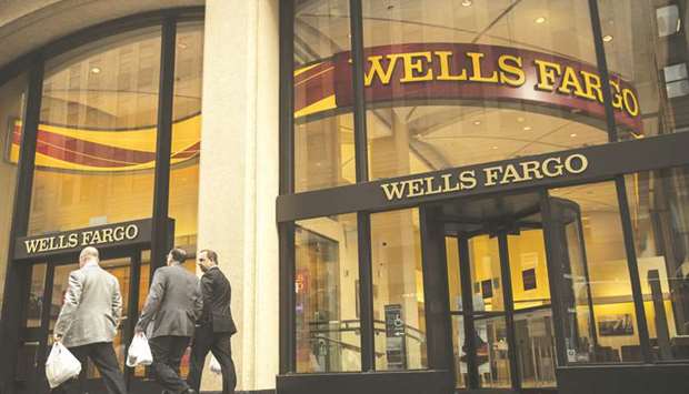 Pedestrians pass in front of a Wells Fargo & Co bank branch in New York. The bank, which employs more people than any other in the US, generated about $330,000 of net revenue per employee last year, sliding behind most major peers.