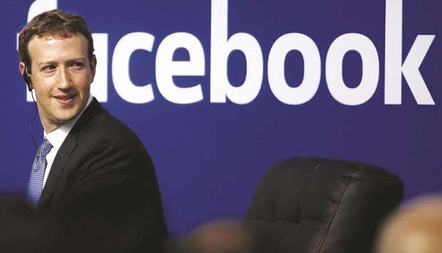 FILE PHOTO: Facebook CEO Mark Zuckerberg, appears on stage during a town hall at Facebooku2019s headquarters in Menlo Park, California.
