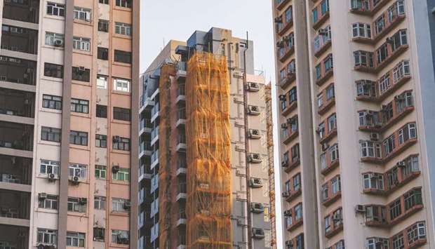 Scaffolding covers sections of the T Plus residential property in Hong Kong. Average new home prices in Chinau2019s 70 major cities rose 0.5% in February, slowing from a 0.6% gain in January and marked the lowest growth rate since April 2018, according to Reuters calculation of data released by the National Bureau of Statistics.