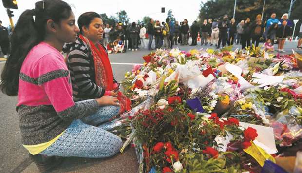 People gather at a memorial to pay tribute to victims of the mosque attacks outside Masjid Al Noor in Christchurch yesterday.