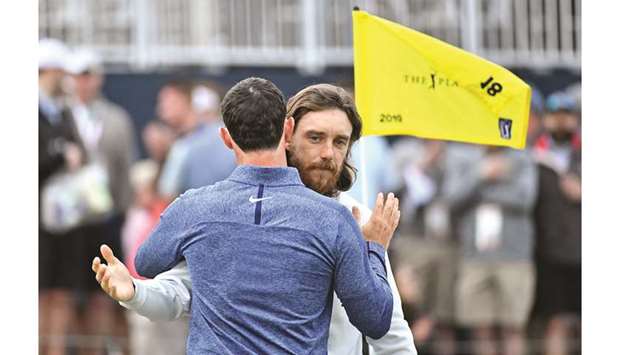 Tommy Fleetwood and Rory McIlroy hug on the 18th green during the third round of The Players Championship on Saturday.