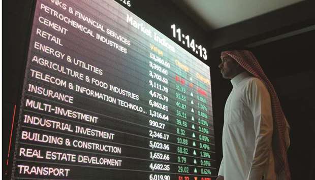 An investor monitors a screen displaying stock information at the Saudi Stock Exchange (Tadawul) in Riyadh (file). Saudi Arabiau2019s inclusion in emerging market stock benchmarks highlights the role of largely opaque players in the kingdomu2019s market: Government funds that could be ready to push the sell button.