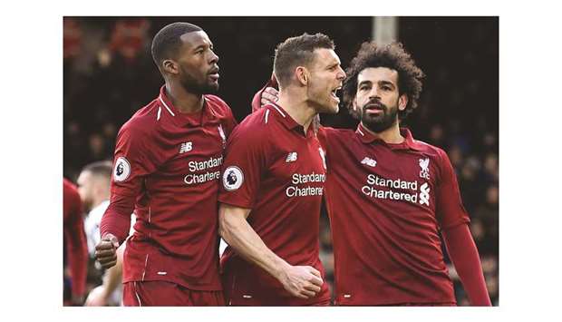 Liverpoolu2019s English midfielder James Milner (centre) celebrates scoring the teamu2019s second goal during the English Premier League match against Fulham at Craven Cottage in London yesterday. (AFP)