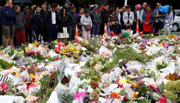 People pray for the victims of a shooting outside Al Noor mosque in Christchurch, New Zealand
