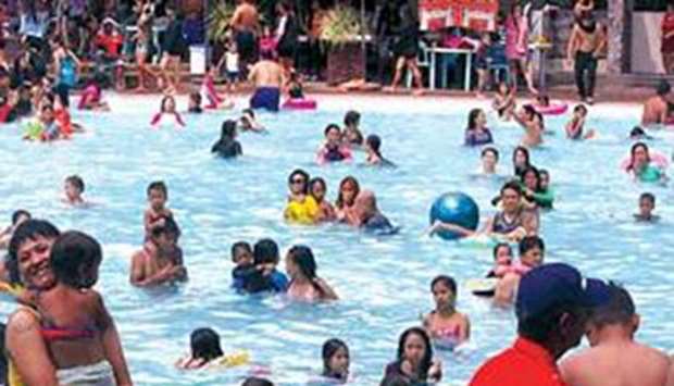 Families spend their weekend swimming at the Rainforest Park in Pasig City amid a water shortage in Metro Manila.