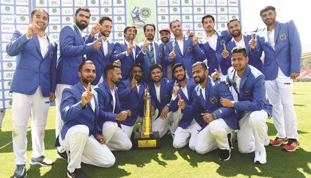 Afghanistan players pose with the trophy after winning the one-off Test match against Ireland in the northern Indian city of Dehradun yesterday. (AFP)
