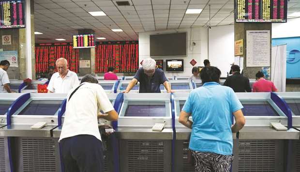 Traders are seen at the Shanghai Stock Exchange. The index rallied 2.5% to 29,409.01 yesterday.