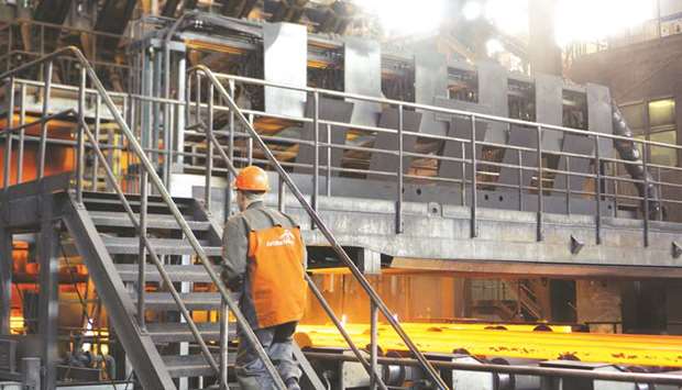 A worker climbs a staircase as hot steel bars pass along the continuous casting production line at the ArcelorMittal metals plant in Kryvyi Rih, Ukraine. A bankruptcy court refused to halt the sale of Essar Steel India to ArcelorMittal, clearing another hurdle for billionaire Lakshmi Mittal as he prepares to enter India after a yearlong struggle.