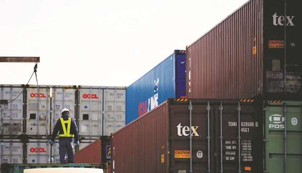A man loads a container on a truck at an industrial port in Tokyo. Japanu2019s Ministry of Finance data showed yesterday exports fell 1.2% year-on-year in February, more than a 0.9% decrease expected by economists in a Reuters poll.