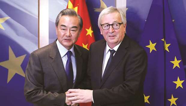 Chinese State Councillor Wang Yi (left) is welcomed by European Commission president Jean-Claude Juncker ahead of a meeting in Brussels. In a veiled reference to Huawei Technologies, which the US says could spy on the West, Wang told Washington to stop its attempts to u201cbring downu201d the company.