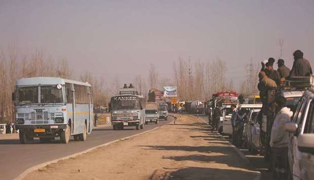 Traffic is stopped as the Central Reserve Police Force (CRPF) convoy moves along a national highway in Qazigund in Kashmir yesterday.
