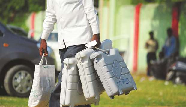 In this file photo taken on May 6, 2014 a polling official carries election materials as he leaves a distribution centre in Allahabad.
