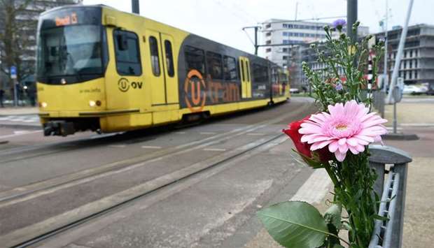 Flowers have been set up in tribute to victims at the site of a shooting in a tram, at 24 October square in Utrecht