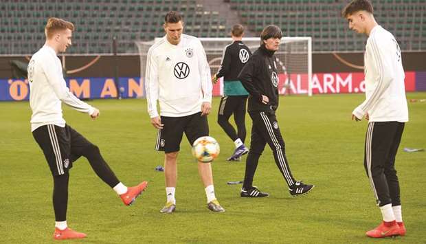 Germany coach Joachim Loew (right) walks past as players train ahead of their friendly match against Serbia in Wolfsburg, Germany, yesterday. (Reuters)