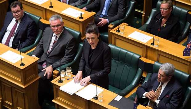 New Zealand Prime Minister Jacinda Ardern (C) speaks at the Parliament Session as members of the parliament Grant Robertson (L), Kelvin Davis (2nd left) and Deputy PM Winston Peters (R) look on in Wellington