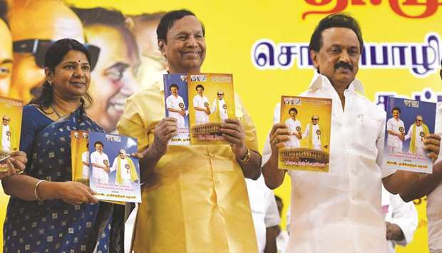 Dravida Munnetra Kazhagam (DMK) party chief M K Stalin (right), party secretary T R Balu (centre) and womenu2019s wing secretary M Kanimozhi, hold the partyu2019s manifesto during its release for the forthcoming general election at the partyu2019s headquarters in Chennai yesterday.