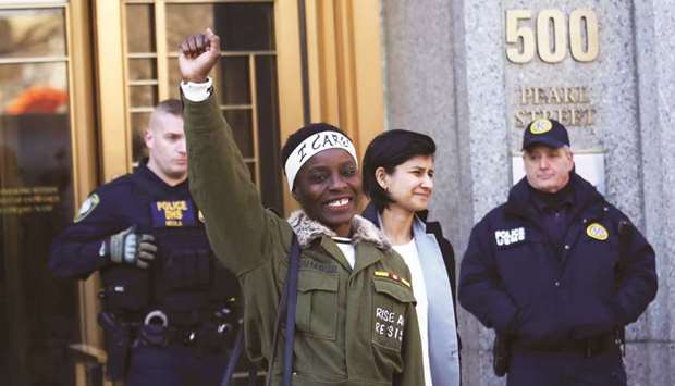 Therese Patricia Okoumou raises her fist after her sentencing outside a federal court in New York yesterday.